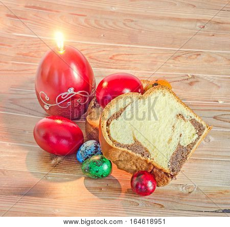 Cakes Cozonac With Smashed Nuts, Traditional Colored Easter Egg, Candle, Wood Background