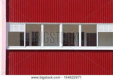 Part of residential building with loggias with double glazing at sunny day