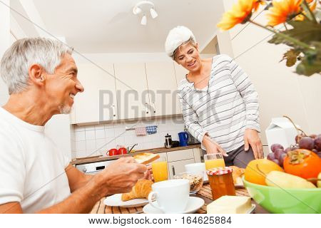 Senior couple enjoying breakfast together in their kitchen