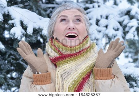 happy mature woman posing outdoors in winter