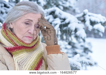 upset mature woman, posing outdoors in winter