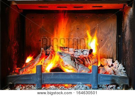 Burning pieces of wood in Fireplace. Stock photo