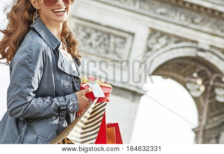 Happy Woman With Christmas Present Near Arc De Triomphe In Paris
