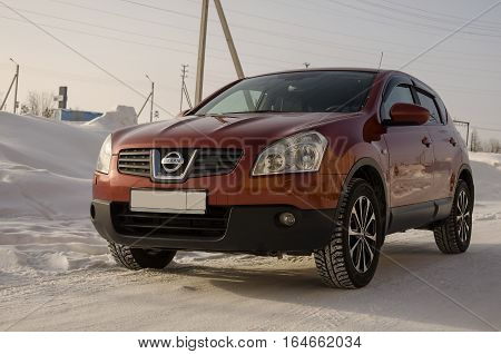 Nissan Qashqai in red color. This is crossover that combines modark design and compact hatchback refinement with functionality