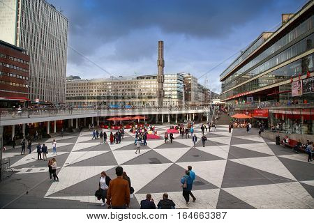 STOCKHOLM SWEDEN - AUGUST 19 2016: Pedestrian walk on Sergels Torg with the glass obelisk Kristallvertikalaccent It is central public square in the city in Stockholm Sweden on August 19 2016.