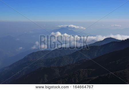 Hills covered by forest and fog. View from Mohare Danda Annapurna Conservation Area Nepal.