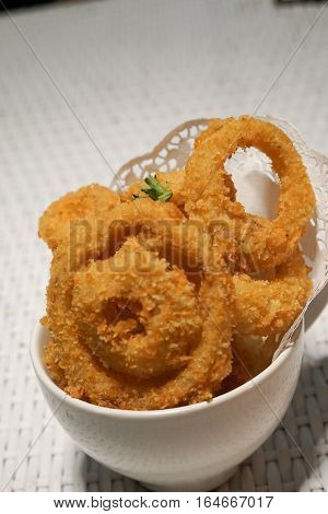 Fried onion rings crisp in a white cup plate deep fried