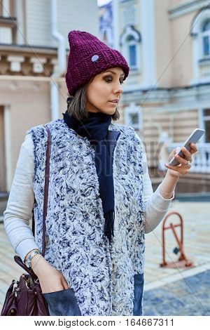 The girl with a smartphone, is walking through the old town