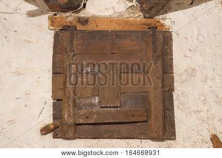 Old wooden window locked of an old house with signs of woodworm in a warehouse vintage