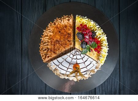Delicious cake on a wooden black background