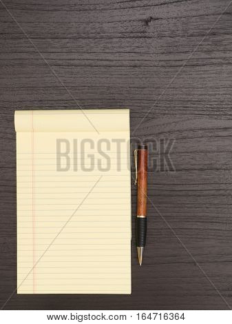 Dark Desktop Yellow Notepad Pen on Desk