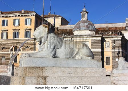 one of the four fountains in the form of a lying lion, around the egyptian obelisk of Ramesses II from Heliopolis stands in the centre of the Piazza del Popolo, Rome, Italy