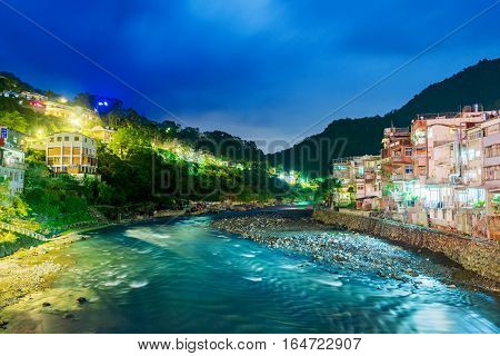 View of Wulai Village at night with river and buildings