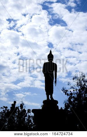 Silhouette of Buddha in a beautiful blue sky.