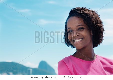 Cheerful woman at Rio de Janeiro with blue sky and copy space outdoor in the summer