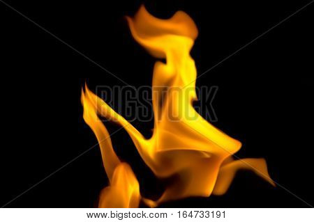 Fire flames isolated on black background. Woman and part of a face silhouette