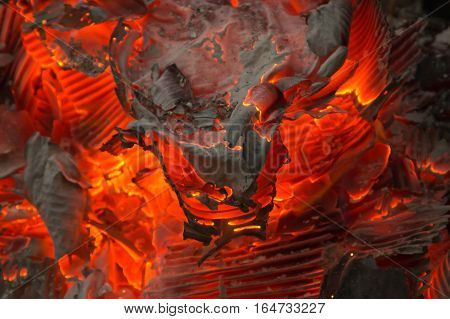 smoldering fire embers with the ashes background