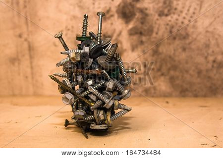 all kind of types of screws on magnet on wooden background