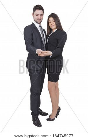 A young businesswoman and businessman are looking in their hands