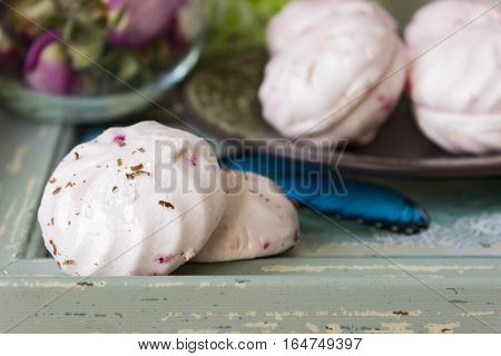 Two halves of a marshmallow on a wooden tray