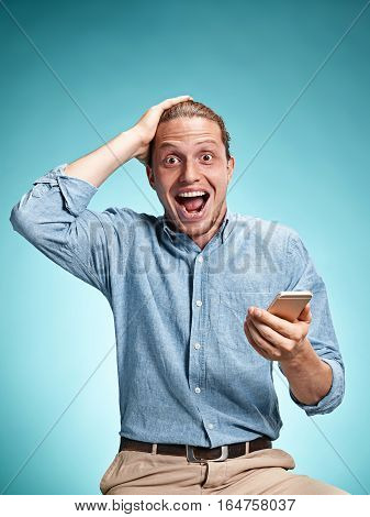 The Young Smiling Caucasian Man On Blue Background