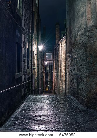 Narrow dark alleyway in Edinburgh's old city