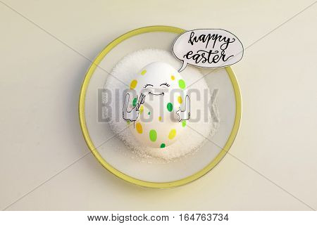 Nice egg on a saucer with hands smiling. Happy easter