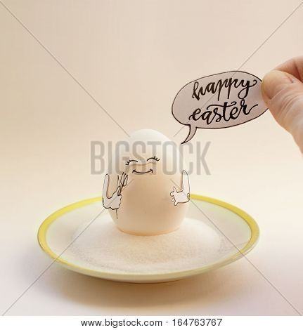 Nice egg on a saucer with hands smiling. Happy easter