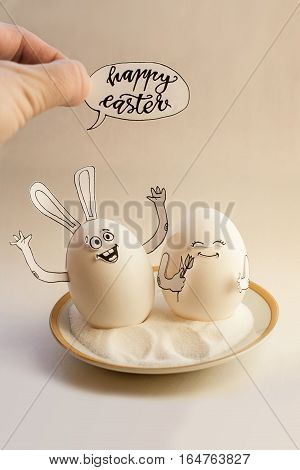 Two funny eggs on a saucer smiling. Happy Easter