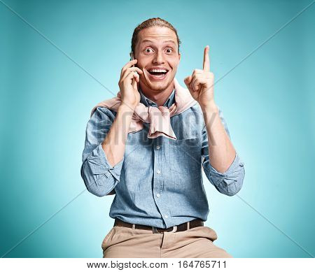 The Young Smiling Caucasian Man On Blue Background