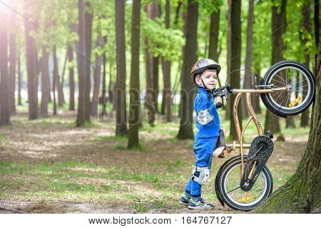 Happy Cute Blond Kid Boy Having Fun His First Bike On Sunny Summer Day, Outdoors.  Child Making Spor