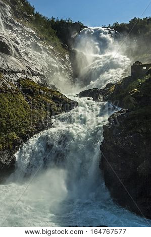 Norway Flam. Kjosfossen famous waterfall on the banks of which stands a beautiful Hyuldra - a mythical character.
