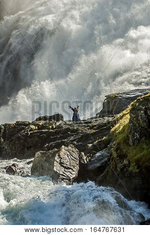 Norway Flam. Kjosfossen famous waterfall on the banks of which stands a beautiful Hyuldra - a mythical character.