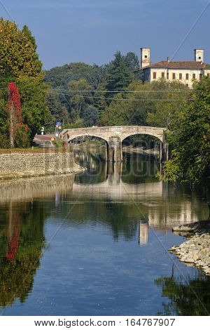 Old bridge over the Naviglio Grande of Turbigo (Milan Lombardy Italy) at fall. Fisheye