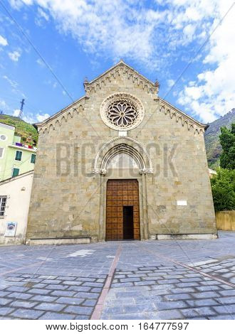 Manarola town Riomaggiore La Spezia province Liguria northern Italy. View of the San Lorenzo church facade monument landmark. Part of the Cinque Terre National Park and a UNESCO World Heritage Site.
