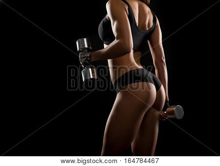 Pump it up. Shot of a young fitness woman with gorgeous body working out with dumbbells