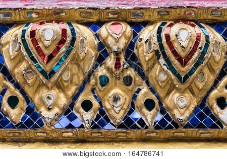 Gloden flower sculpture with glass mosaic on the church wall in the Thai temple. (Public area not required Property Release)