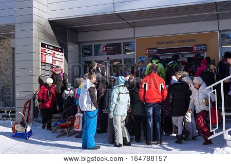 SLOVAKIA STARY SMOKOVEC - JANUARY 06 2015: The crowd in the queue for tickets to cable car in High Tatras mountains. Smokovec is a popular resort for skiing and hiking at an altitude of 990 m a.s.l.