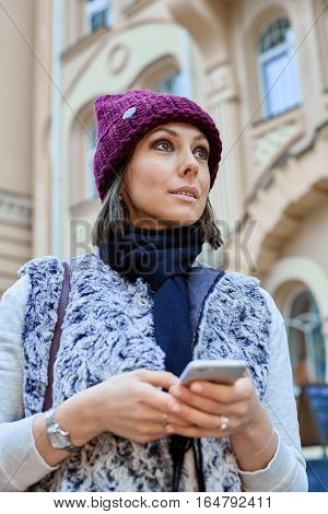 The girl with a smartphone, is walking through the old town