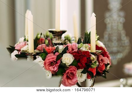 Beautiful bouquet of flowers and candles in the room