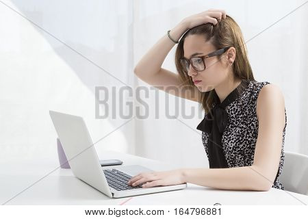 Young executive working in the office at the computer