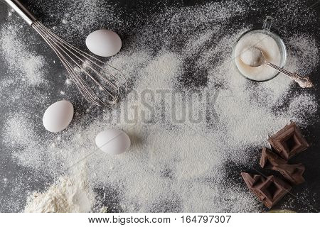 Baking Cake Ingredients. Bowl, Flour, Eggs, Eggbeater On Black Chalkboard From Above. Cooking Course