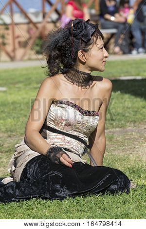 CAGLIARI, ITALY - June 1, 2014: Sunday at La Grande Jatte public gardens - Sardinia - portrait of a beautiful woman in Victorian costumes