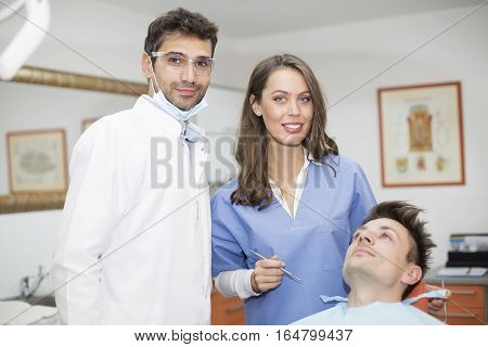 Young Man Having Dental Chekup At Dentist Office
