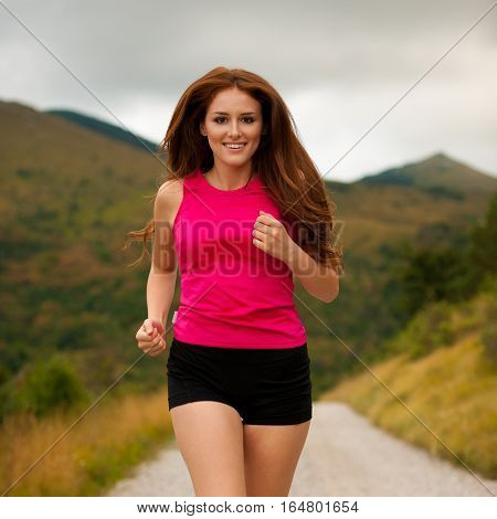 Runner - Woman Runns  On A Forest Road - Outdoor  Workout
