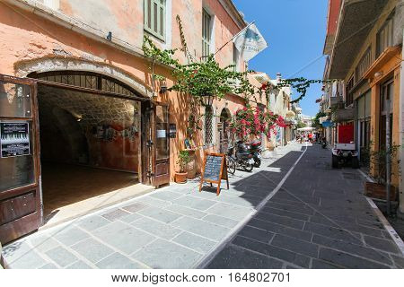 Rethymnon, Island Crete, Greece- July 1 2016: The narrow street of Rethymnon (part of Old Town) where there are a lot of small cafes and shops