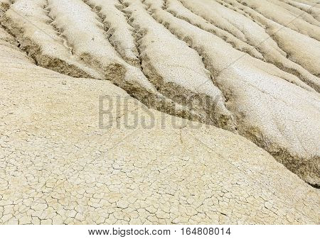 Vintage Close-up With Dried Ground Covered With Cracks. Dried Out Creek Bed Over Arid Area Of Sparse