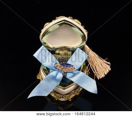 Valentine's sapphire ring box tied with blue ribbon