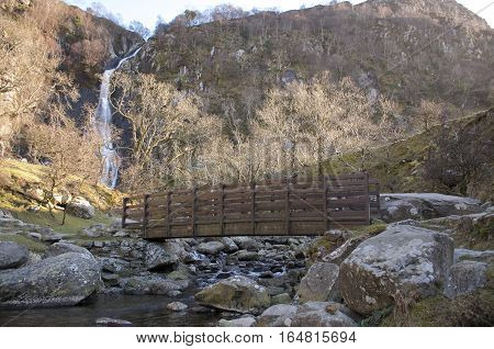 Aber Falls Bridge with river bellow and waterfall in the background, Winter landscape. Abergwyngregyn North Wales UK