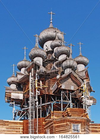KARELIA KIZHI RUSSIA - June 2014: North Russian wooden architecture - open-air museum Kizhi. Church of the Transfiguration 1714. Restoration of the method of lifting. The whole structure is held due to the internal metal frame.